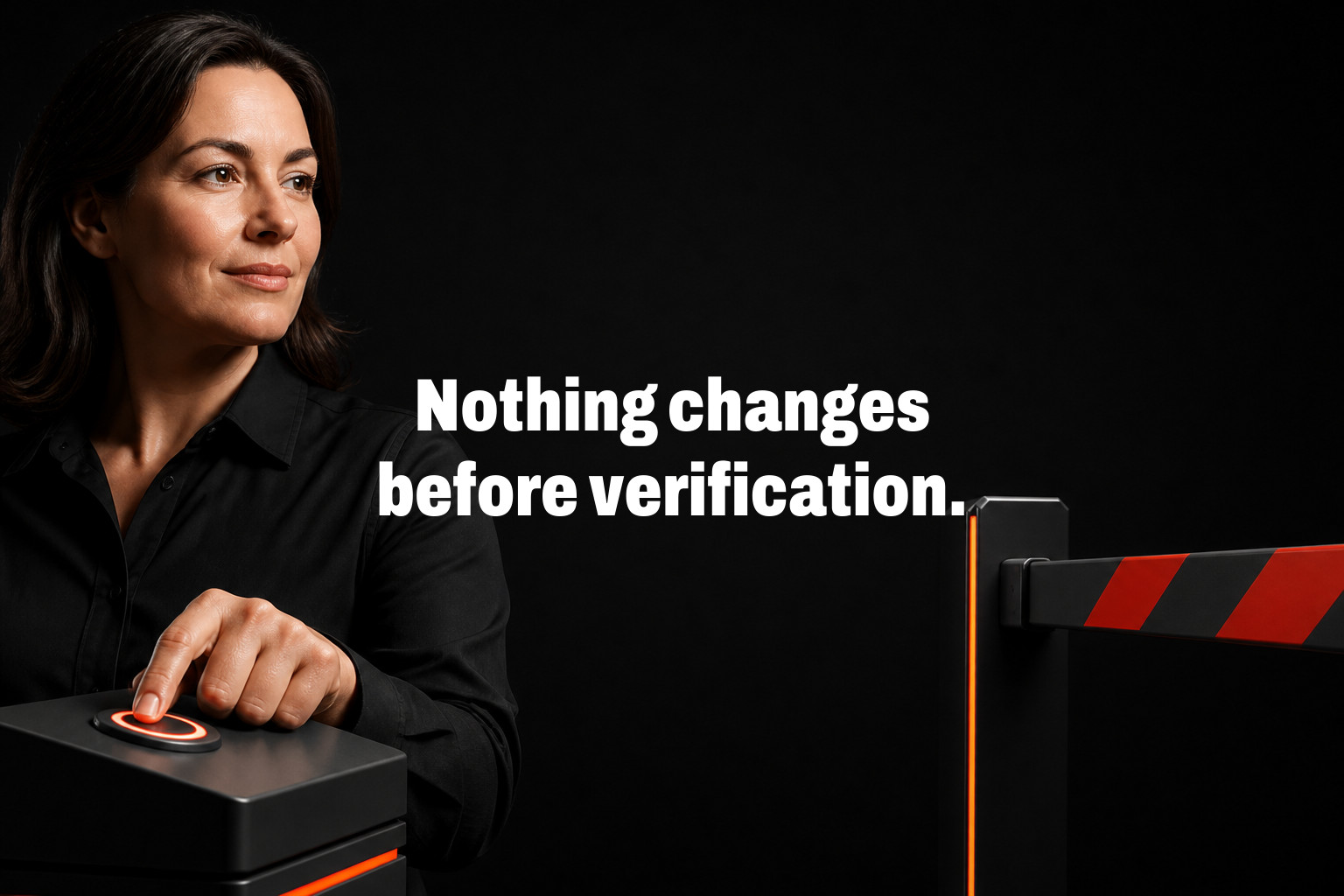 Nothing changes before verification. Woman presses a lit button on a black pedestal beside a striped barrier in a dark studio.