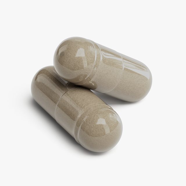 A pair of Human Runtime Attention™’s capsules close up, the powder inside showing through the shell.