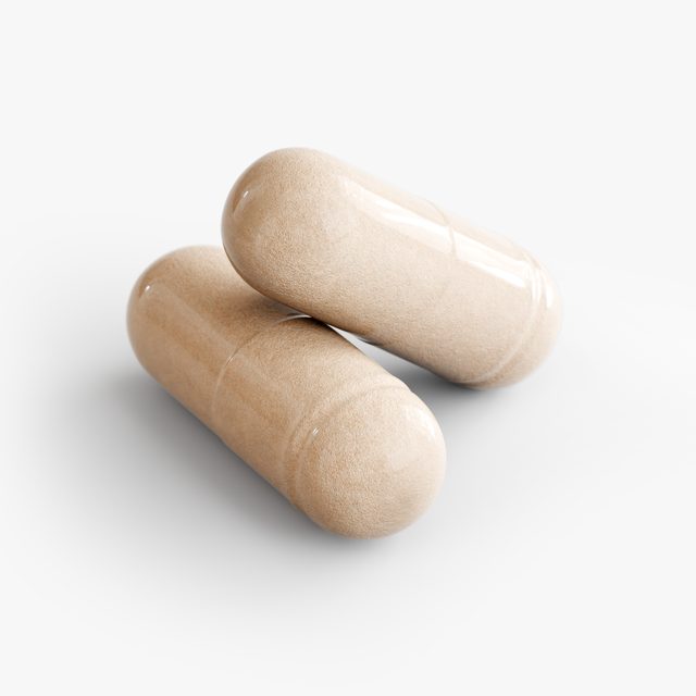 A pair of Human Runtime Regulator™’s capsules close up, the powder inside showing through the shell.