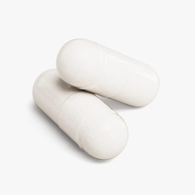 A pair of Human Runtime Substrate™’s capsules close up, the powder inside showing through the shell.